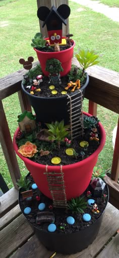 three tiered potted planter filled with plants