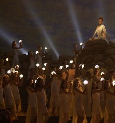 a group of people holding torches in their hands