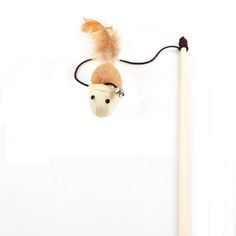 a wooden stick with a stuffed animal on it's head next to a pencil