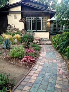 a brick walkway leading to a house