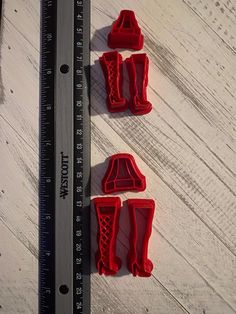 three cookie cutters sitting next to a ruler