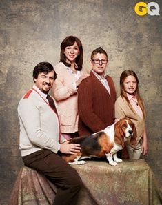 a family posing for a photo with their dog