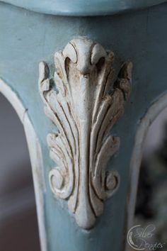 an ornately decorated table with blue paint