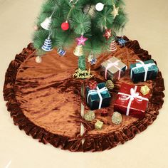 presents under a christmas tree on a brown blanket