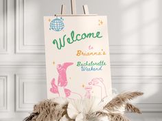 there is a welcome sign on top of a stuffed animal