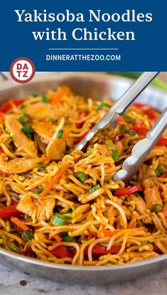 a bowl filled with noodles and chicken on top of a table