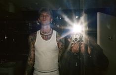 a man taking a selfie in front of a mirror with the light shining on him