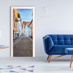 an open door with a painting of a cobblestone street