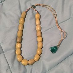 Jade Necklace With Large ~0.75" Stones. The Stones Were Sourced Separately And Strung Together With Green Fabric Tie. Some Spots And Natural Color Variation Are Present. Amber Wooden Beads For Jewelry Making, Beige Large Beads Jewelry Gift, Traditional Adjustable Single Strand Jewelry, Beige Wooden Beads Jewelry As A Gift, Beige Hand-strung Jewelry For Gifts, Lampwork Glass Pendants, Shell Beads Necklace, Butterfly Necklace Gold, Swarovski Beads