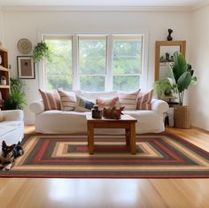 a living room filled with furniture and a dog laying on the floor next to it