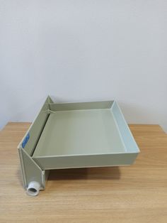 an empty tray sitting on top of a wooden table