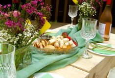 a table topped with plates and glasses filled with food