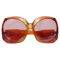 These fabulous vintage YSL Sunglasses are a must have for your endless wardrobe! Perfect for anyone who loves large scale sunglasses, these statement sunnies are an essential for the summertime. The vibrant orange tones would pair gorgeously with a printed Chanel sundress or to add a pop of color with your neutral toned Prada ensemble. There are truly endless ways to style these! In excellent vintage condition, please see photos.