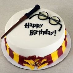 a harry potter birthday cake with glasses and wands on the top is ready to be eaten