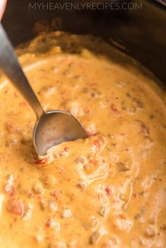 a ladle scooping some food out of the slow cooker to be cooked