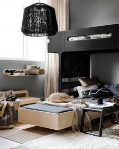 a loft bed in the middle of a living room with lots of pillows and blankets