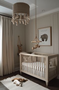 a baby's room with a white crib and beige curtains