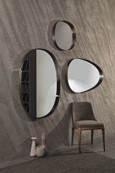 a chair and mirror in front of a wall with circular mirrors on it's sides