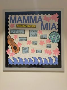 a bulletin board with the words mamma mia written on it and a ukulele