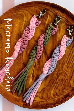 four different colored tassels on a wooden tray