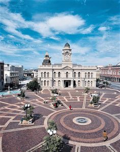 a large building with a clock tower in the middle of it's center square