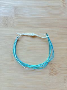 preppy summer pura vida wax string bracelet!! Blue Adjustable Cord Jewelry For Vacation, Blue Jewelry With Adjustable Cord For Vacation, Adjustable Blue Friendship Bracelets For Vacation, Blue Bohemian Friendship Bracelets For Everyday, Trendy Turquoise Friendship Bracelets With Sliding Knot, Trendy Blue Braided Bracelets For Vacation, Blue Braided Bracelet With Sliding Knot For Summer, Trendy Beach Friendship Bracelets With Waxed Cord, Blue Nylon Cord Friendship Bracelets For Beach