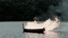 a boat is on the water with fire coming out of it's back end