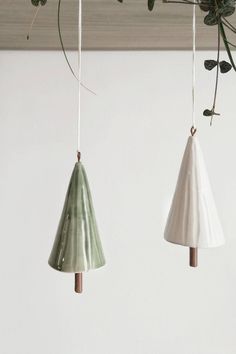 three ceramic hanging planters with plants in them