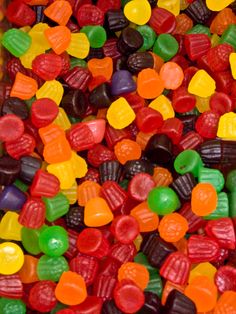 many different colored candy candies are in a box on the table and there is no image here to provide a caption for