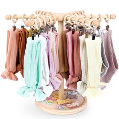 a rack with several scarves hanging from it's hooks on a white background