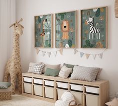 a room with two giraffes hanging on the wall and several storage bins