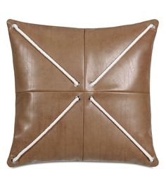 a brown leather pillow with white stitching on the front and back ends, in two different colors