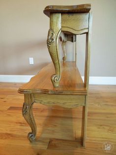 an old wooden table with a clock on it's top and bottom shelf in the middle