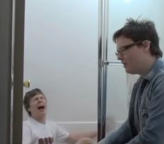 a man and boy are laughing in the bathroom