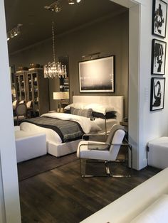 a large bed sitting in the middle of a living room next to a white couch