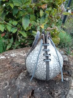 a white purse sitting on top of a tree stump