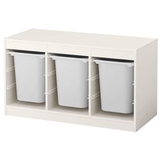 a white shelf with three bins on it