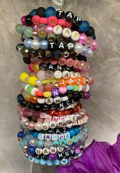 PRICED TO SELL: I'm selling off my remaining dance bracelet inventory to make room for next year's batch. Most are sized at 6.5 inches, but I can re-thread to fit your specified size. Additional discount for buying multiples; please send a message if you would like a quantity not shown in the option selections.  Friendship bracelets to show off your love for dance! A great gift idea for birthdays or recitals.  Bracelets are made with stretch cord, and beads vary between 6mm and 8mm. Custom sizin Party Bracelets With Round Letter Beads, Party Bracelet With Letter And Round Beads, Party Stretch Bracelet With Letter Beads, Adjustable Party Bracelets With Letter Beads, Adjustable Letter Beads Bracelets For Party, Adjustable Round Beaded Bracelets For Rave, Beaded Rave Bracelets For Gifts, Personalized Multicolor Beaded Bracelets For Party, Party Beaded Bracelets With Letter Beads And Round Beads