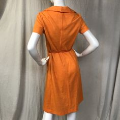 "This is a lovely short sleeve dress in a bright cheery tangerine. There's a zipper (19\") down the back with hooks at the top for the collar. The sleeves are short. There are two pockets at the waist. The belt is included. Details Size: unmarked, fits a modern 4 - 6 Bust: 36\" Sleeve length: 7\" Shoulder: 14.5\" Waist: 32\" Hips: 36\" Length: 41\" Belt: 26\" - 31\" Label: unmarked Colors: Tangerine Condition: Excellent, no issues." Fitted Collared Short Sleeve Spring Dress, Fitted Collared Short Sleeve Dress For Spring, Vintage Orange A-line Dress, Orange Fitted Dress For Daywear, Mod Mini Dress With Short Sleeves, Vintage Orange Dress For Daywear, Vintage Fitted Mini Dress With Short Sleeves, Orange Vintage A-line Dress, Vintage Orange Knee-length Dress