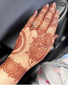 a woman's hand with henna on it