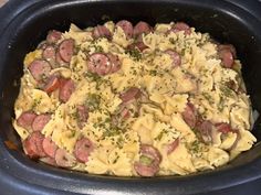 a crock pot filled with pasta and meat