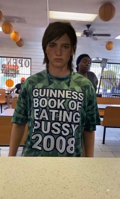 a young man standing in front of a counter