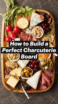 a wooden platter filled with cheese, meats and vegetables next to crackers