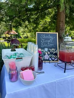 a table topped with drinks and ice creams next to a sign that says sunday sample station