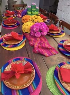 the table is set with colorful plates and napkins for mexican themed dinner party decorations