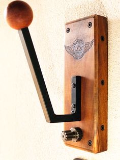 a wooden door handle mounted to the side of a wall