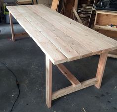 a wooden table is being built in a shop