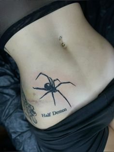 a woman with a spider tattoo on her stomach and the words half demon written in black ink