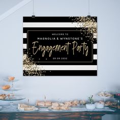 a black and white sign with gold confetti on it that says engagement party