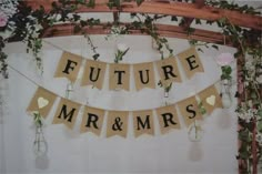 there is a sign that says future mr and mrs hanging from the side of a wall